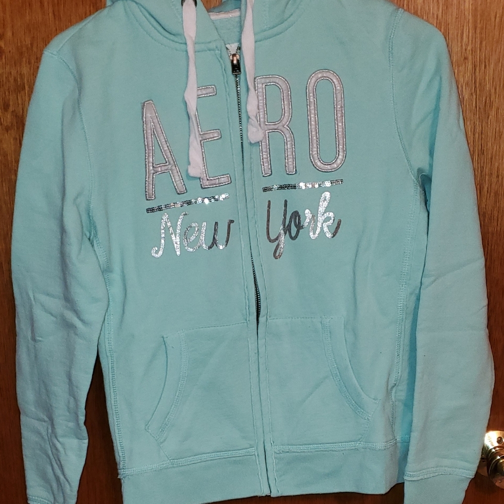 Light blue hoodie with sequin writing